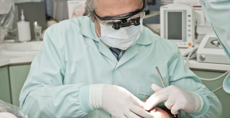 dentist examining patient’s mouth