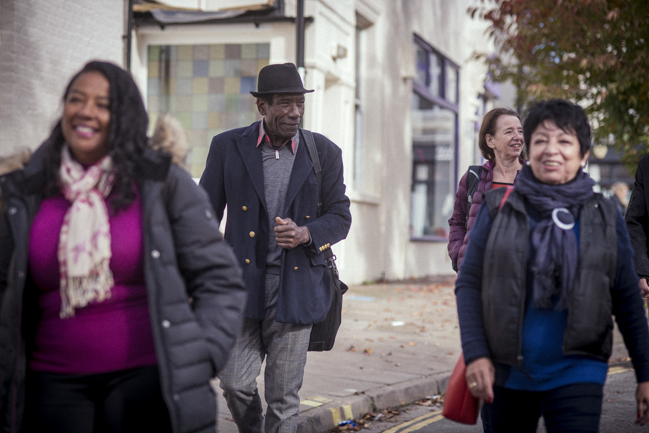 Group of older people walking down a street