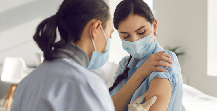 medical professional giving an injection to a young woman