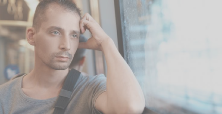 man sitting on a bus looking out of the window