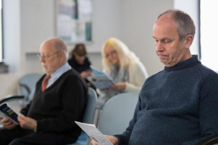 people sitting in a GP waiting room 