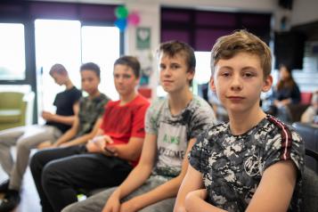 Young boys sitting in a row in a classroom