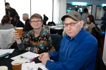 Man and woman sitting in a busy room