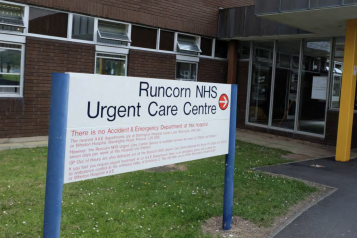 A sign to Runcorn Urgent Care