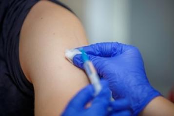 arm being swabbed prior to receiving an injection
