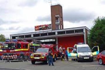 photo of Runcorn fire station with fire engines and cars outside on display. 