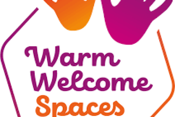 'Warm Welcome Spaces' Image of 2 hand prints in purple and orange. 