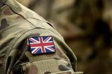 Armed forces Union Jack emblem, on camouflaged uniform. 