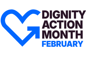 The design features a blue heart-shaped outline with an arrow integrated into it, pointing forward. The text "DIGNITY ACTION MONTH" is in bold, uppercase black letters, and "FEBRUARY" is highlighted in blue