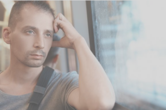 man sitting on a bus looking out of the window