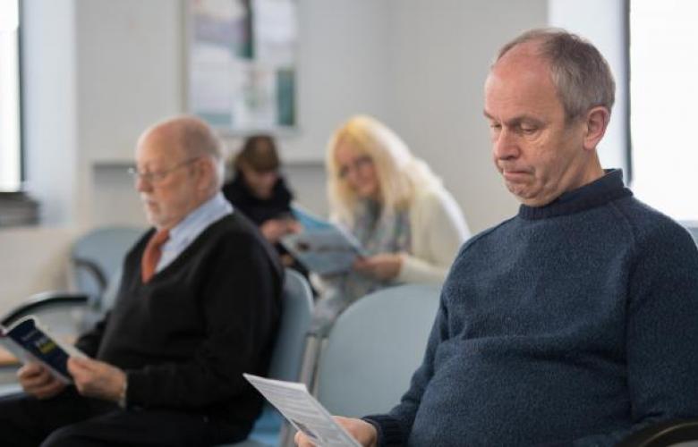 people sitting in a GP waiting room 